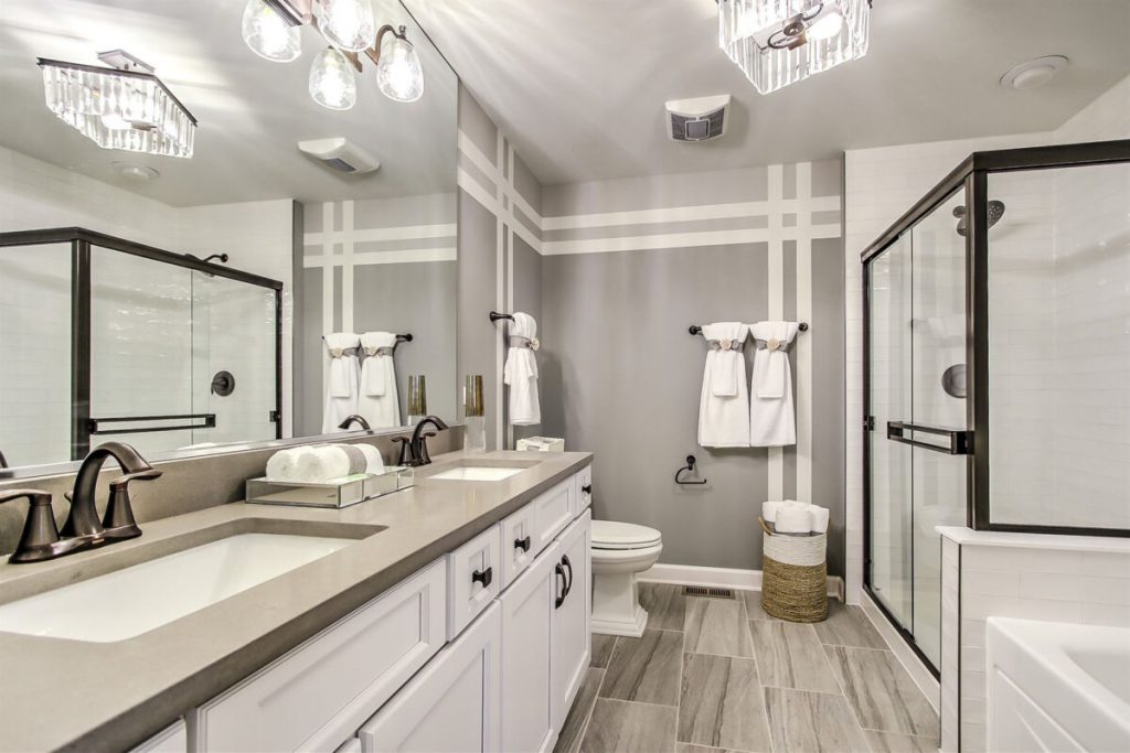 Bathroom with stripes pained on the wall.