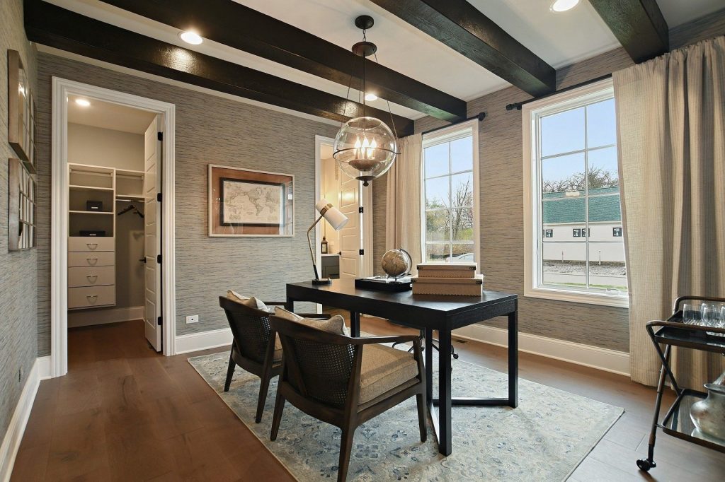 Study with grey patterned wallpaper, white trim, and black beams to match the furniture.